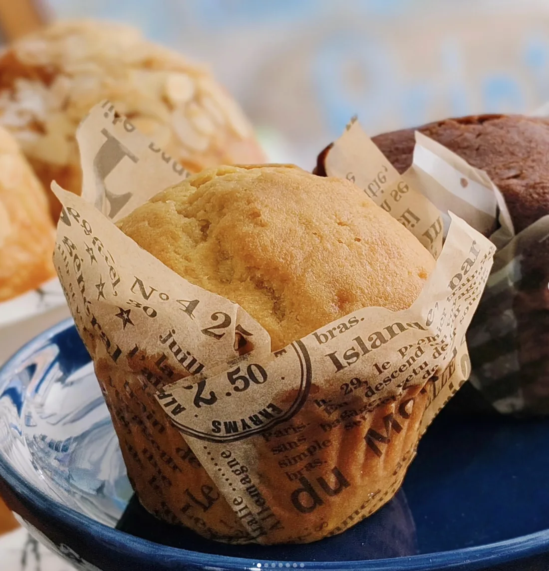 Muffins in newspaper wrappers, freshly baked